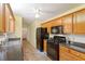 Traditional-style kitchen with wooden cabinets, black appliances, and a ceiling fan at 2395 Holly Branch Dr, Cumming, GA 30040