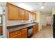 Functional kitchen with wooden cabinets and laminate countertops, leading to other rooms at 2395 Holly Branch Dr, Cumming, GA 30040