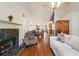 Comfortable living room with a fireplace, hardwood floors, vaulted ceiling, and natural light at 2395 Holly Branch Dr, Cumming, GA 30040