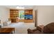 Well-lit living room with custom wood built-ins, comfortable seating, and a view to the back yard at 2395 Holly Branch Dr, Cumming, GA 30040