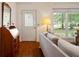 Bright living room featuring hardwood floors, a decorative mirror, and a view to front yard at 2395 Holly Branch Dr, Cumming, GA 30040