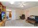 Relaxing living room featuring a couch, a comfortable chair, and an easy view to an adjacent sun room at 2395 Holly Branch Dr, Cumming, GA 30040
