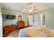 Bright main bedroom with hardwood floors, a ceiling fan, and ensuite bathroom access at 2395 Holly Branch Dr, Cumming, GA 30040