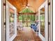 Relaxing screened porch with wood floors and ceiling, comfortable seating, and a view of the woods at 2395 Holly Branch Dr, Cumming, GA 30040