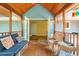 Inviting porch with blue furniture, wood floors, and a view leading to the interior of the home at 2395 Holly Branch Dr, Cumming, GA 30040