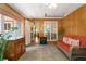 Relaxing sun room with wood paneling, ceramic tile floor, and a view to the surrounding yard at 2395 Holly Branch Dr, Cumming, GA 30040