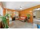 Bright sun room with wood paneling, ceramic tile floor, and a view to the surrounding yard at 2395 Holly Branch Dr, Cumming, GA 30040