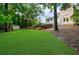 Manicured backyard with a lush lawn, a shed, mature trees, and privacy landscaping at 270 Park Bridge Ln, Roswell, GA 30075