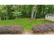 Lush backyard featuring mature trees, privacy landscaping, and a shed at 270 Park Bridge Ln, Roswell, GA 30075