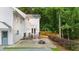 Spacious backyard with a patio, fire pit, lush landscaping, and wooded views at 270 Park Bridge Ln, Roswell, GA 30075