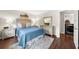 Inviting bedroom with wood floors, dresser, and a view into the laundry room at 270 Park Bridge Ln, Roswell, GA 30075