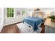 Comfortable bedroom with warm wood floors, a plush rug, and lots of natural light at 270 Park Bridge Ln, Roswell, GA 30075