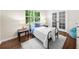 Cozy bedroom with wood floors, natural light, and a comfortable bed with side tables at 270 Park Bridge Ln, Roswell, GA 30075