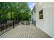 View of backyard featuring a wooden deck with metal railings, pool area, and mature trees at 270 Park Bridge Ln, Roswell, GA 30075