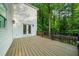 Spacious wood deck with black metal railing adjacent to wooded area, accessible via double doors at 270 Park Bridge Ln, Roswell, GA 30075
