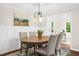 Bright dining room with hardwood floors, wainscoting and a view to adjacent rooms at 270 Park Bridge Ln, Roswell, GA 30075