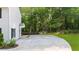 Long concrete driveway with ample parking space, leading to a home surrounded by lush greenery at 270 Park Bridge Ln, Roswell, GA 30075