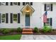 Close-up of the front entrance featuring a blue door, brick steps, and classic white siding and trim at 270 Park Bridge Ln, Roswell, GA 30075