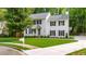 Beautiful two-story home on a corner lot with manicured lawn and mature trees, with a traditional mailbox at 270 Park Bridge Ln, Roswell, GA 30075