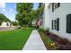 Exterior view of a home with an American flag, beautiful landscaping, and manicured lawn at 270 Park Bridge Ln, Roswell, GA 30075