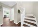 Hallway with stairs and view into the kitchen featuring hardwood floors and lots of light at 270 Park Bridge Ln, Roswell, GA 30075