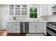 A bright kitchen featuring stainless appliances, white cabinetry, and hardwood floors at 270 Park Bridge Ln, Roswell, GA 30075