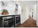 Convenient laundry area features modern washer and dryer, built in shelf and storage at 270 Park Bridge Ln, Roswell, GA 30075