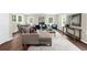 Bright living room features hardwood floors, ample natural light and modern decor at 270 Park Bridge Ln, Roswell, GA 30075