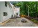 Stone patio with outdoor firepit and stairs to an elevated wooden deck for entertaining at 270 Park Bridge Ln, Roswell, GA 30075