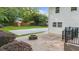 Backyard brick patio with a charming firepit, a grassy area, and a small shed at 270 Park Bridge Ln, Roswell, GA 30075