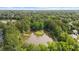Aerial view of a neighborhood pond with fountain, walking trails, and lush green foliage at 270 Park Bridge Ln, Roswell, GA 30075