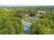 Aerial view of community tennis courts featuring multiple blue and green courts surrounded by lush trees at 270 Park Bridge Ln, Roswell, GA 30075