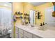 Bright bathroom with a white vanity, large mirror, and a shower with a floral curtain, offering a fresh and clean space at 510 Curry Ridge Ct, Locust Grove, GA 30248