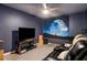 Cozy bedroom with a ceiling fan, entertainment center, and Star Wars decor at 510 Curry Ridge Ct, Locust Grove, GA 30248