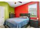 Comfortable bedroom with grey furniture, pops of color from the walls, and lots of natural light from the window at 510 Curry Ridge Ct, Locust Grove, GA 30248