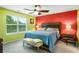 Relaxing bedroom with a window view, a bed with blue bedding, and colorful walls at 510 Curry Ridge Ct, Locust Grove, GA 30248