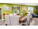 Bright dining room with green walls, a wooden table, and comfortable upholstered chairs, perfect for Gathering gatherings at 510 Curry Ridge Ct, Locust Grove, GA 30248