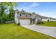 Beautiful two-story home featuring a two-car garage, well-kept lawn, and traditional design elements at 510 Curry Ridge Ct, Locust Grove, GA 30248