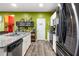 Well-equipped kitchen with granite counters, stainless appliances, and a door leading to a pantry at 510 Curry Ridge Ct, Locust Grove, GA 30248