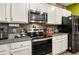 Close-up of kitchen with stainless appliances, granite countertops, and modern finishes at 510 Curry Ridge Ct, Locust Grove, GA 30248