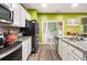 Well-lit kitchen with granite countertops, stainless appliances, and access to a screened-in porch at 510 Curry Ridge Ct, Locust Grove, GA 30248