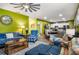 Open concept living room flowing into a dining area, featuring comfortable sofas and a kitchen in the background at 510 Curry Ridge Ct, Locust Grove, GA 30248