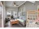 Relaxing sunroom with comfortable seating, ceiling fan, and natural light at 510 Curry Ridge Ct, Locust Grove, GA 30248
