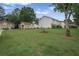 Large grassy backyard ideal for activities, lined by trees and backing up to other houses at 6076 Chupp Way Ln, Lithonia, GA 30038