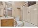Clean bathroom with a toilet, sink, and shower with glass doors at 6076 Chupp Way Ln, Lithonia, GA 30038