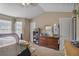 Spacious bedroom featuring a dresser, window, and overhead lighting at 6076 Chupp Way Ln, Lithonia, GA 30038