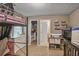Functional bedroom with a bunk bed, dresser, and closet for ample storage at 6076 Chupp Way Ln, Lithonia, GA 30038