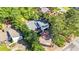 Overhead angle showing the house with patio and privacy fence, plus lush green trees at 1048 Indian Hills Pkwy, Marietta, GA 30068