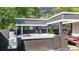 Backyard hot tub with corrugated steel roofing, black privacy walls and tiered fountain at 1048 Indian Hills Pkwy, Marietta, GA 30068