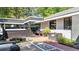 Private backyard stone paver patio featuring black trim, bench seating and an outdoor living area at 1048 Indian Hills Pkwy, Marietta, GA 30068